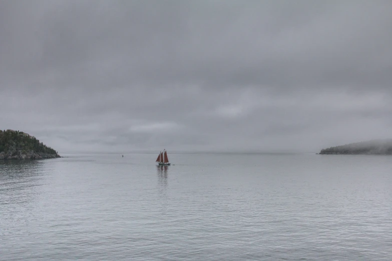 two boats on the water near an island