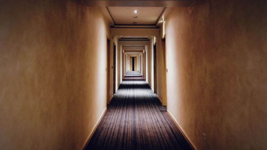 a long empty hallway lined with light on the ceiling