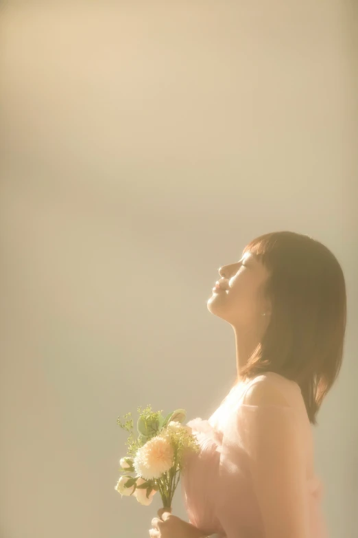 an image of a young woman with a bouquet of flowers