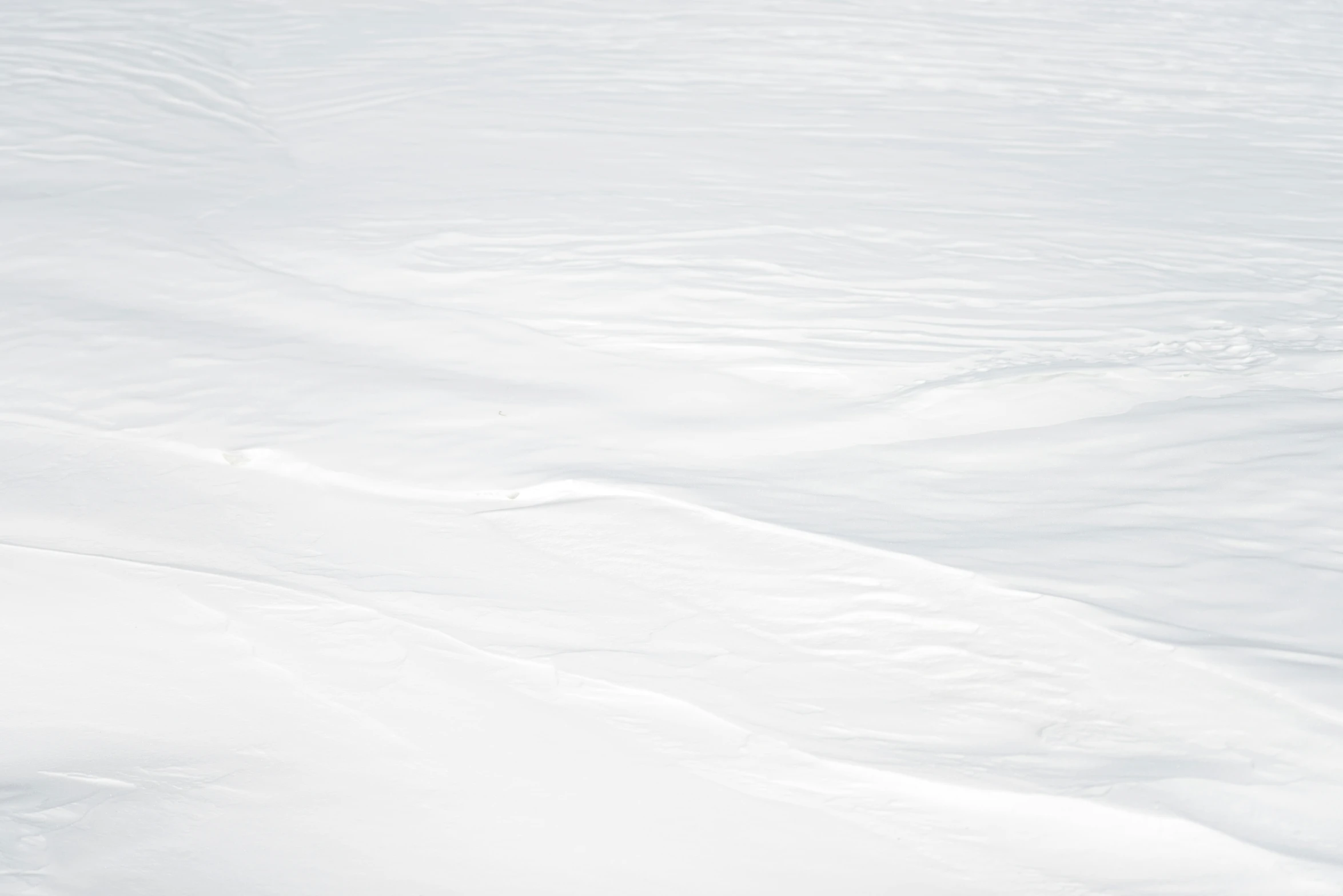 a man riding skis down a snow covered slope