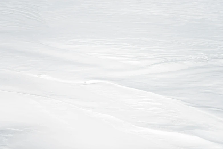 a man riding skis down a snow covered slope