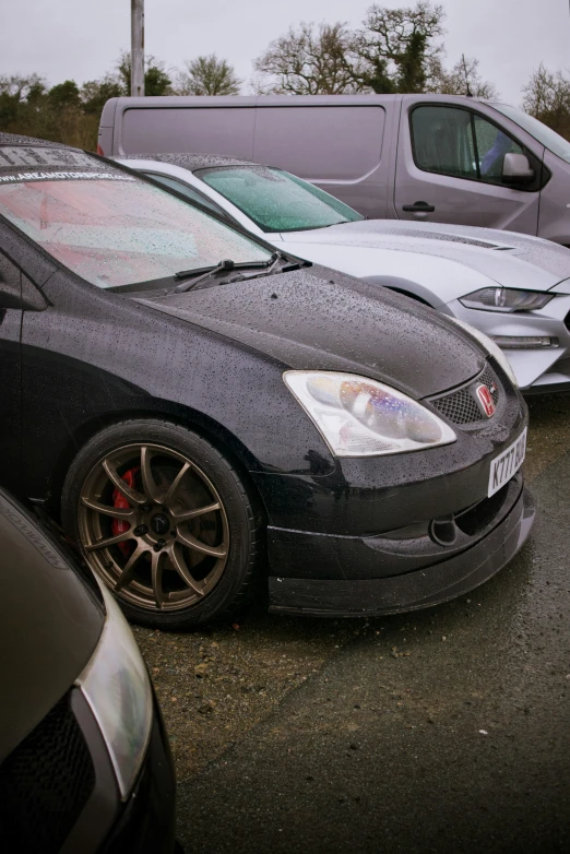 many cars are parked in a lot next to each other