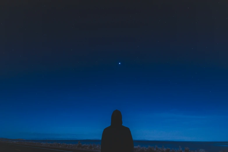 a person standing in the grass at night