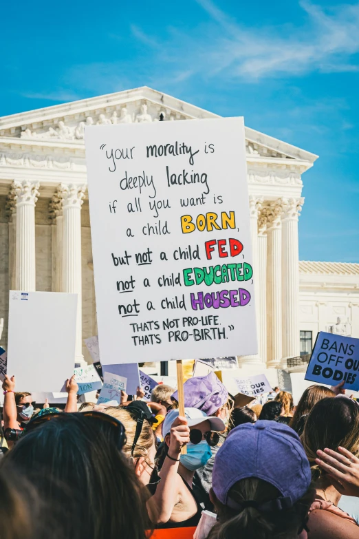 the protesters are holding up signs outside of the supreme court