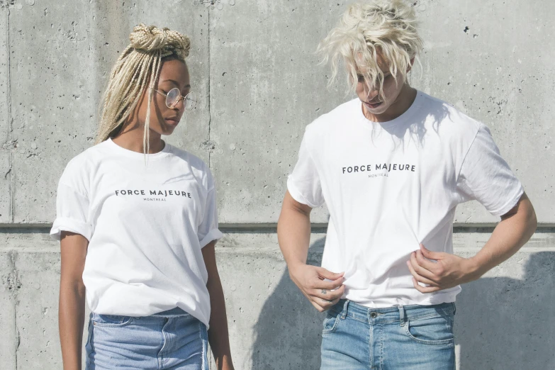 the man and woman are wearing shirts with writing on them