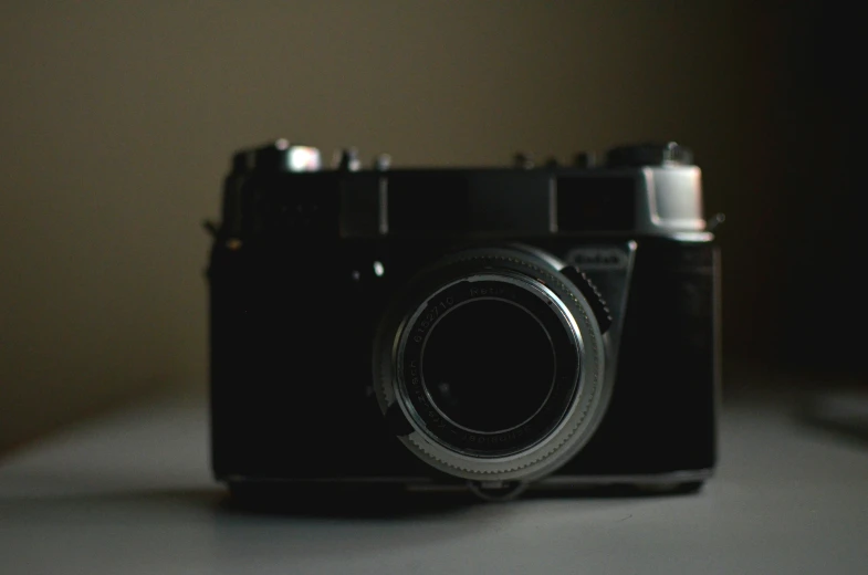 a black camera sitting on top of a table