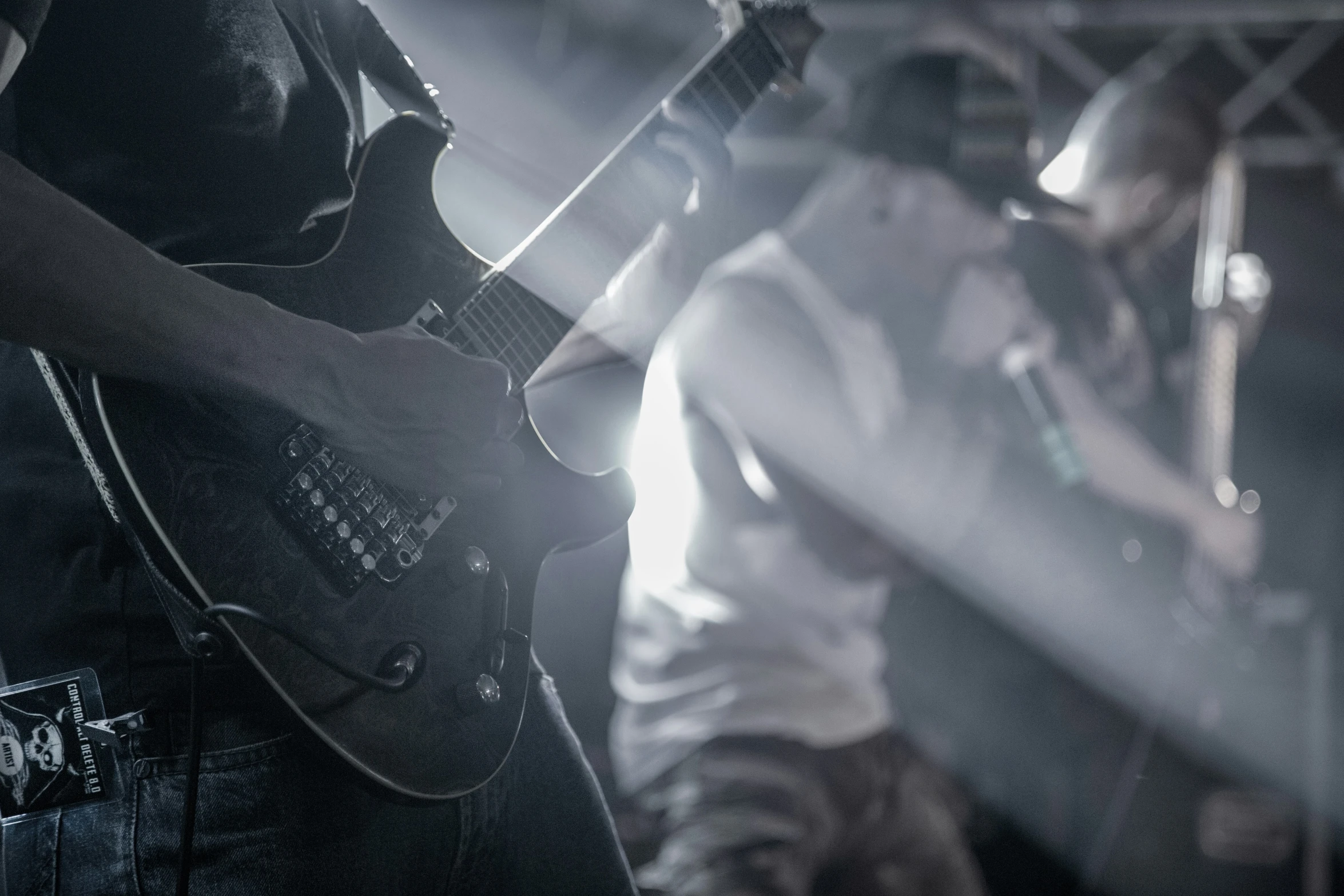 three people on stage with guitars and other instruments