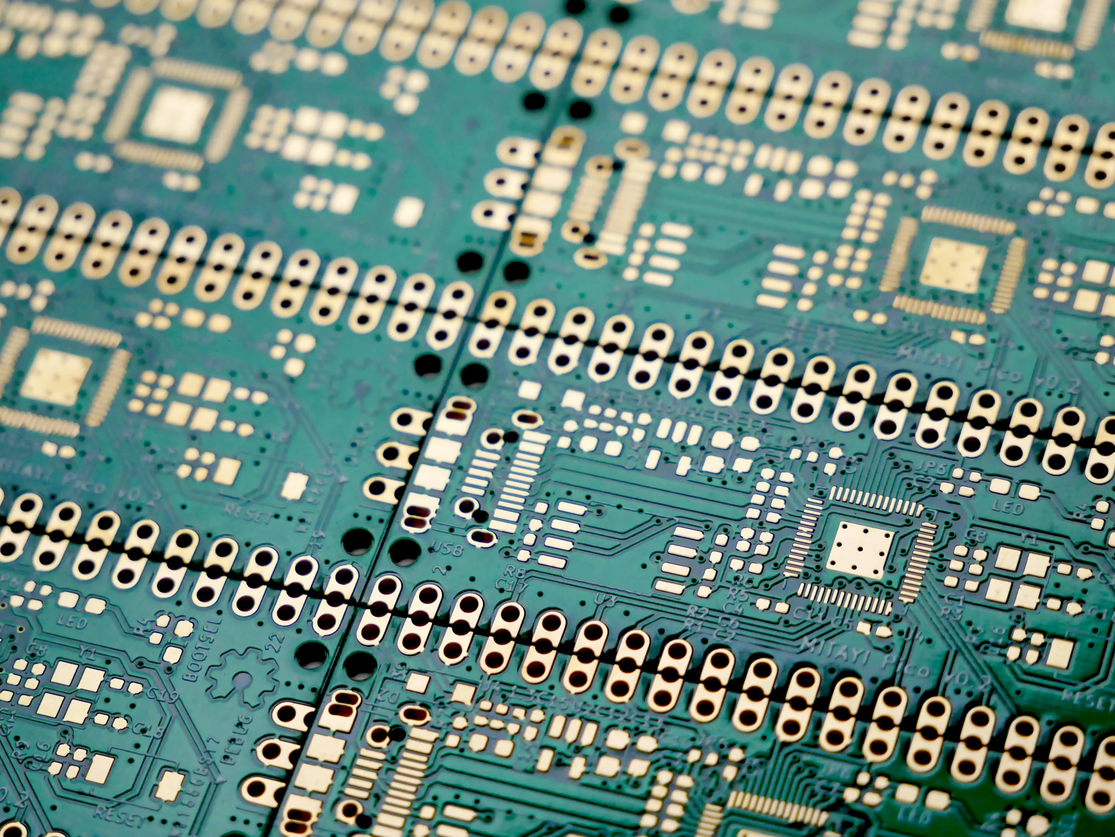 close up s of electronic components showing many rows of small white dots on the top