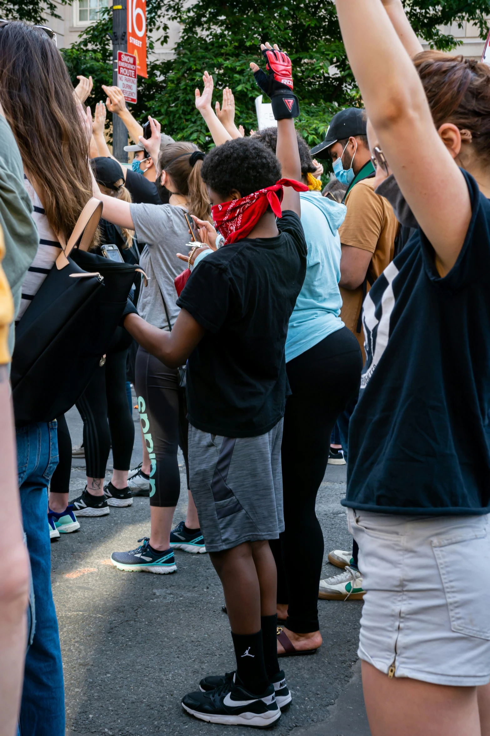 group of people marching down city street in protest