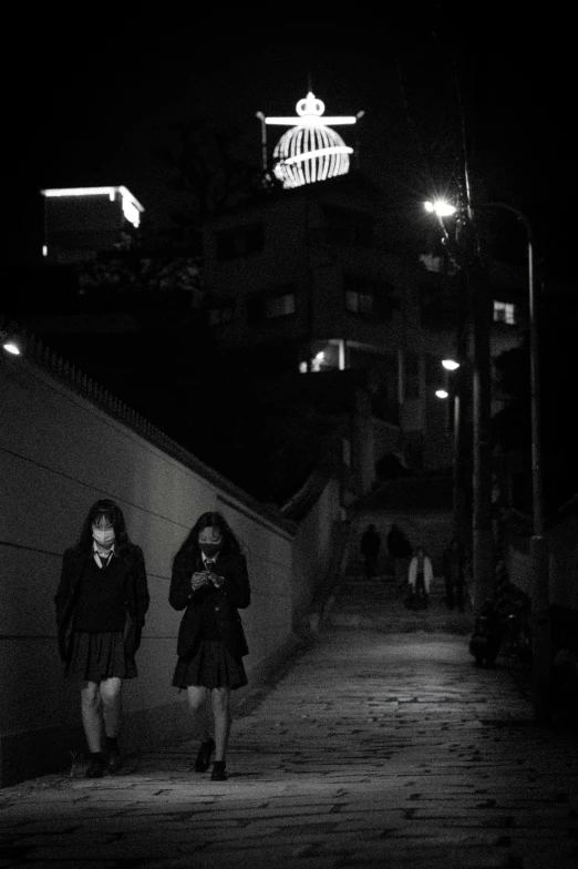 two people are walking up the steps at night