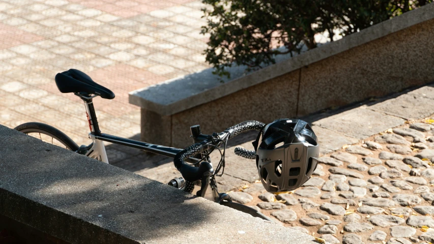 a bicycle that has its ke on is parked by a wall