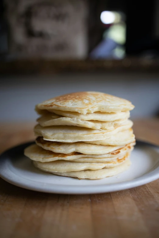 stack of pancakes on a white plate ready for eating