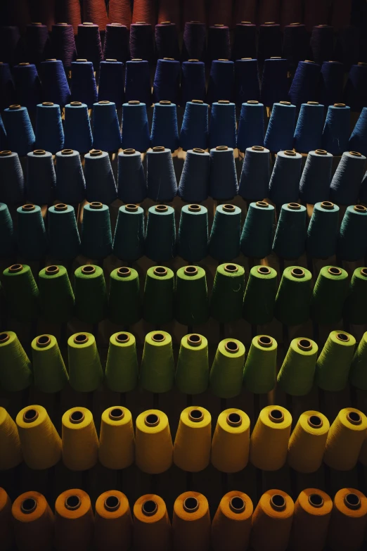 several spools of thread are stacked on a shelf