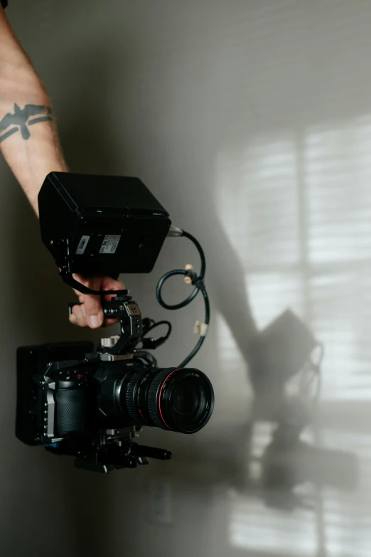 the hands of a person holding a video camera