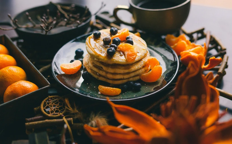 a plate that has some pancakes with blueberries