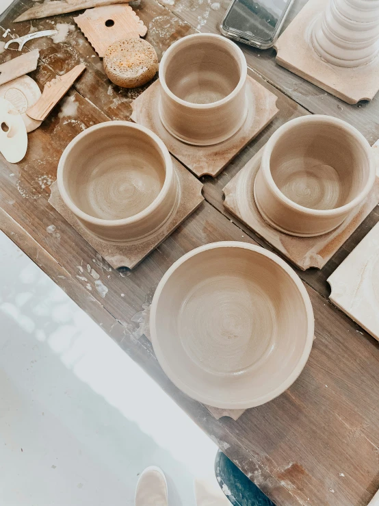 small pieces of pottery with a variety of plates and spoons on a table