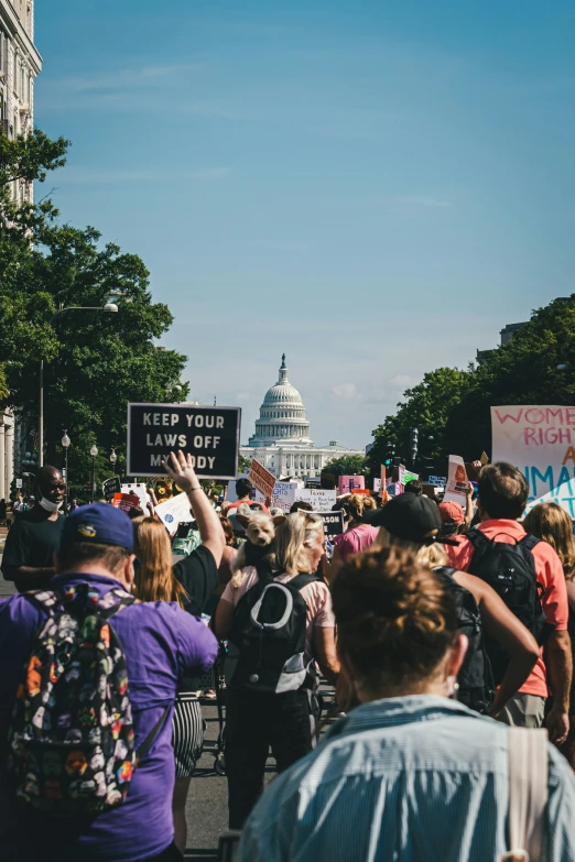 a group of people protesting on a city street