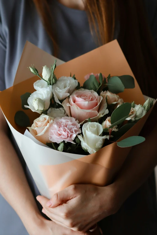 a woman holding up a bunch of flowers