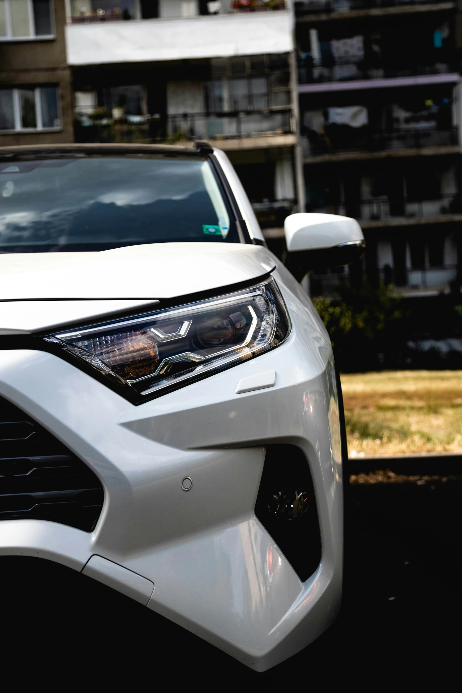 a white car that is parked next to a building