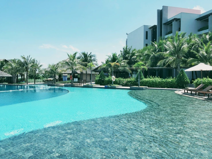 some umbrellas and chairs sitting around a large pool