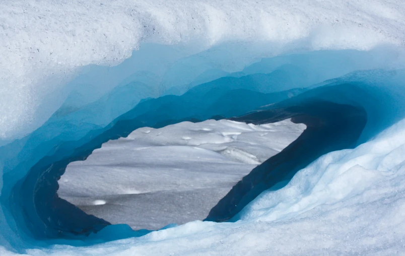 the view of an icy area from inside an ice cave