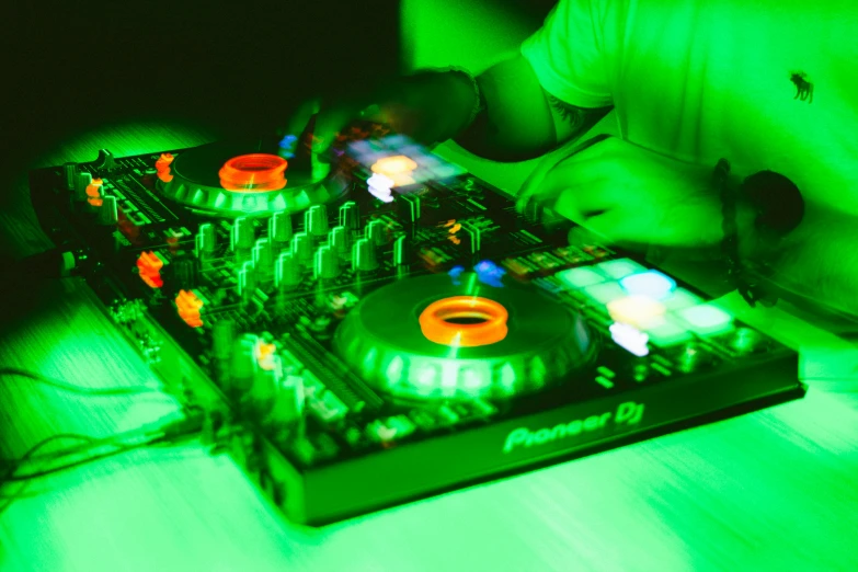 a dj mixes music on a controller board