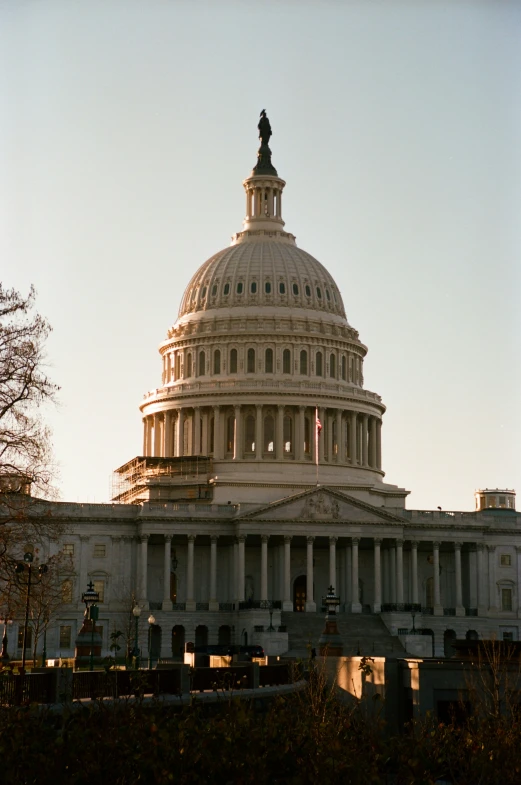 a white building with a steeple that has an american flag