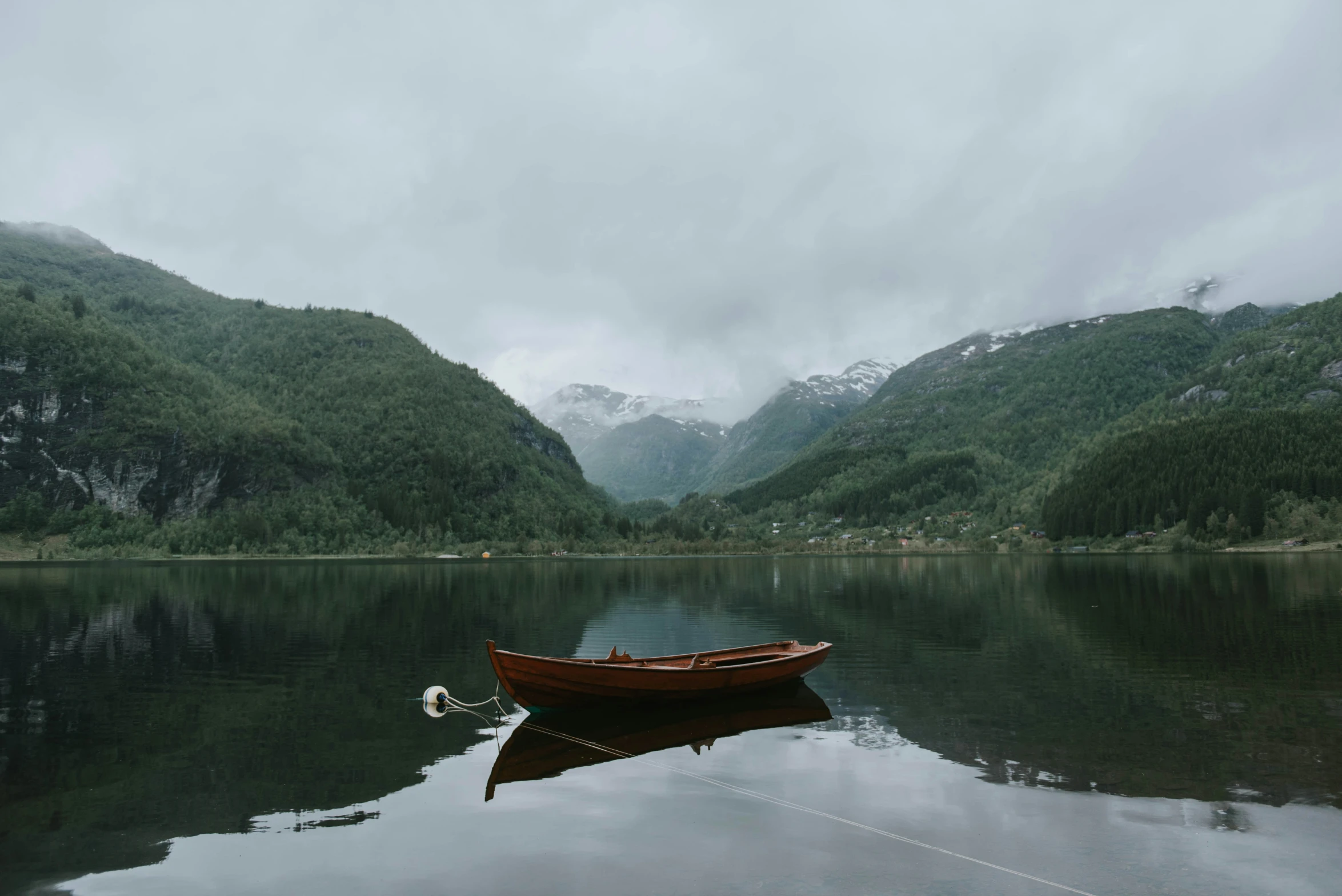 a single boat that is in a still water lake