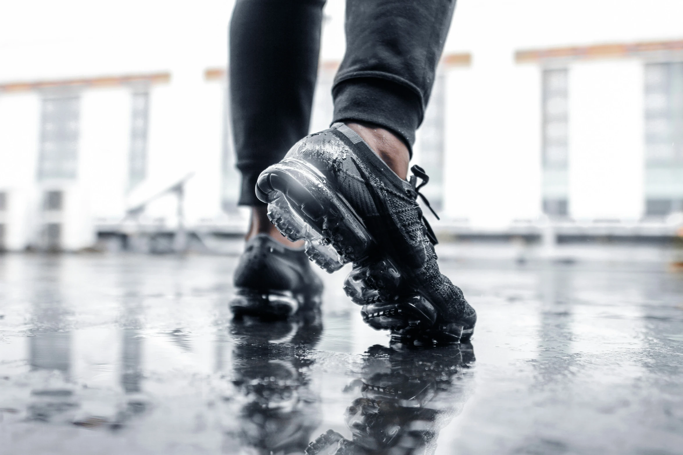 a person walks on a wet surface outside