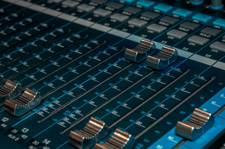 some metal gears laying on top of a sound mixing mixer