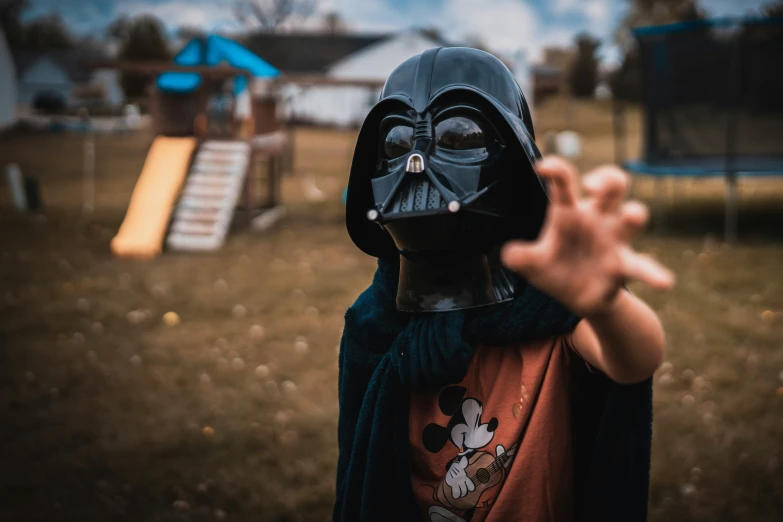 a  wearing a star wars helmet is in the park