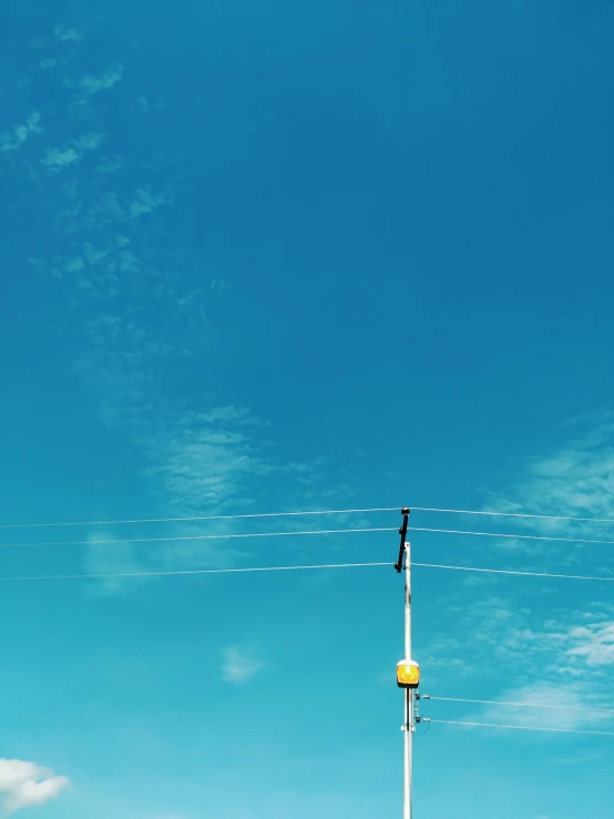 traffic signal sitting on top of pole with power lines overhead