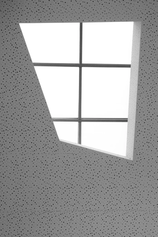 a square window with a small amount of dots and white paper on the outside