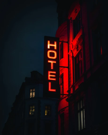 a neon el sign at night in the city