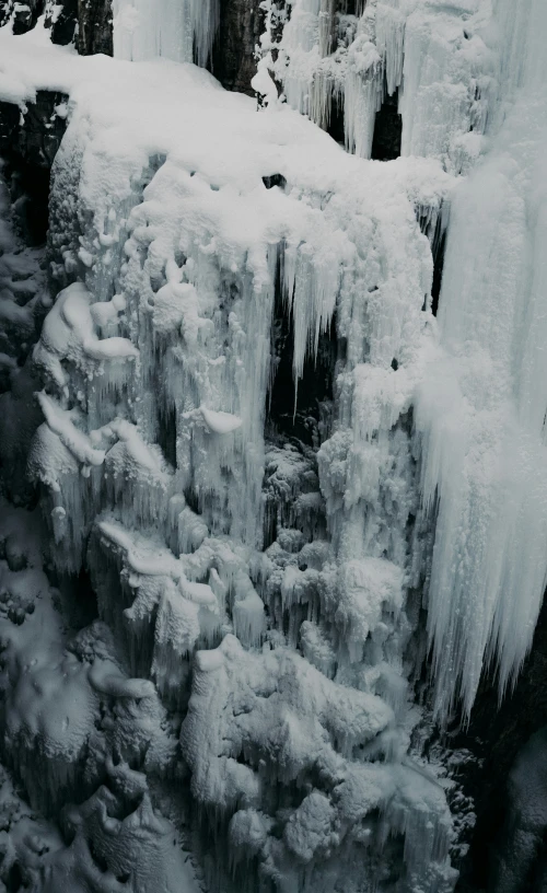 an ice covered waterfall is pographed from above