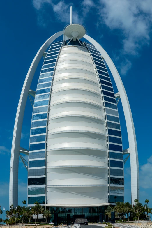 a tall burj building sitting on top of a beach