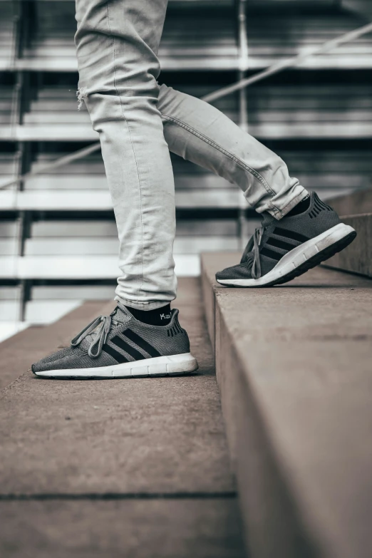 a person stepping up stairs on a skateboard