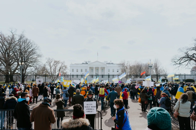 a crowd of people are protesting at the white house