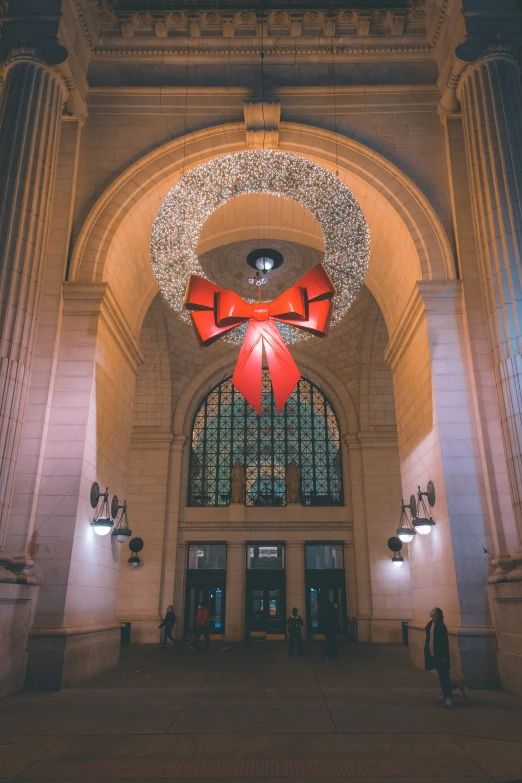 a very large christmas decoration hangs over a doorway