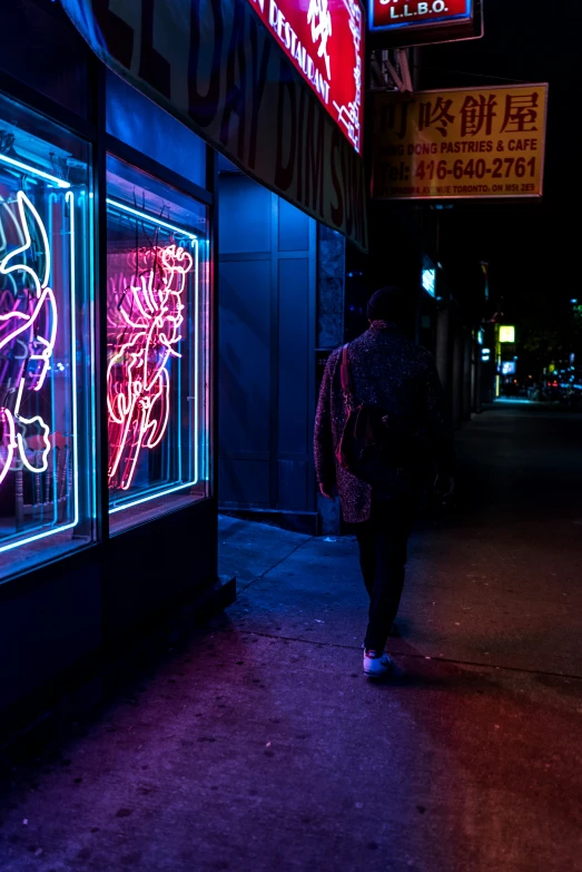 a person with a backpack walks down the street