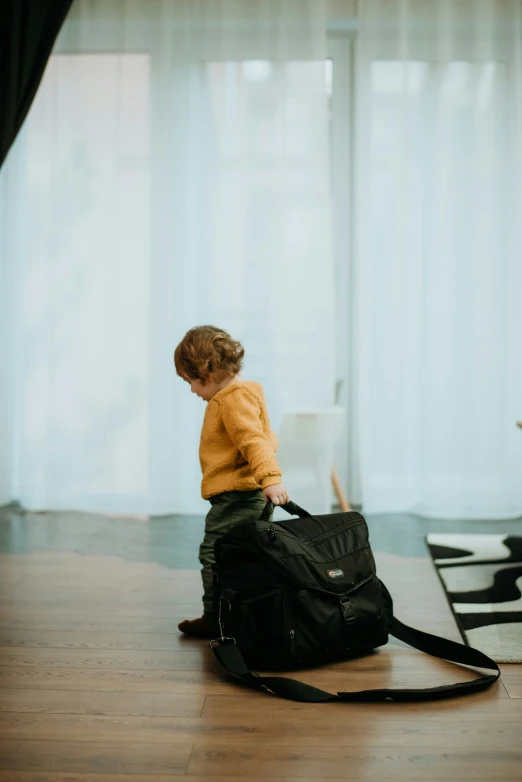 a young child is looking at soing in the bag