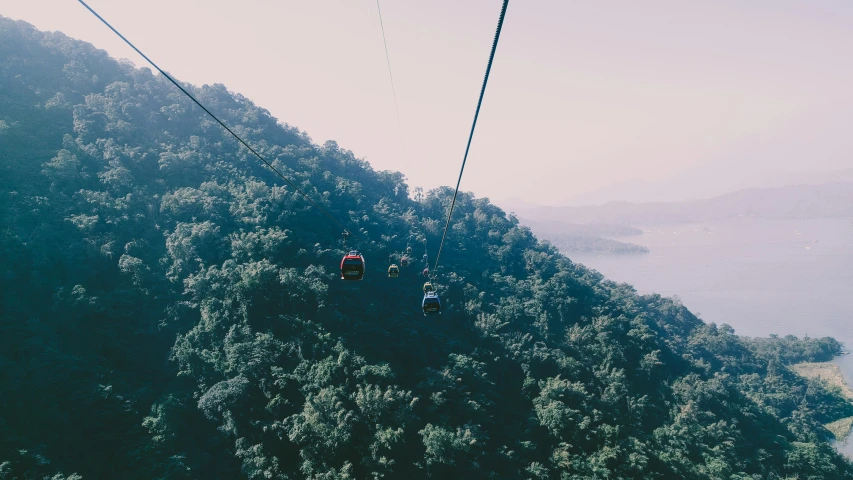 the sky lift has two people suspended by cables