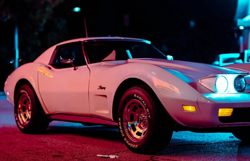 a light blue mustang standing in the street