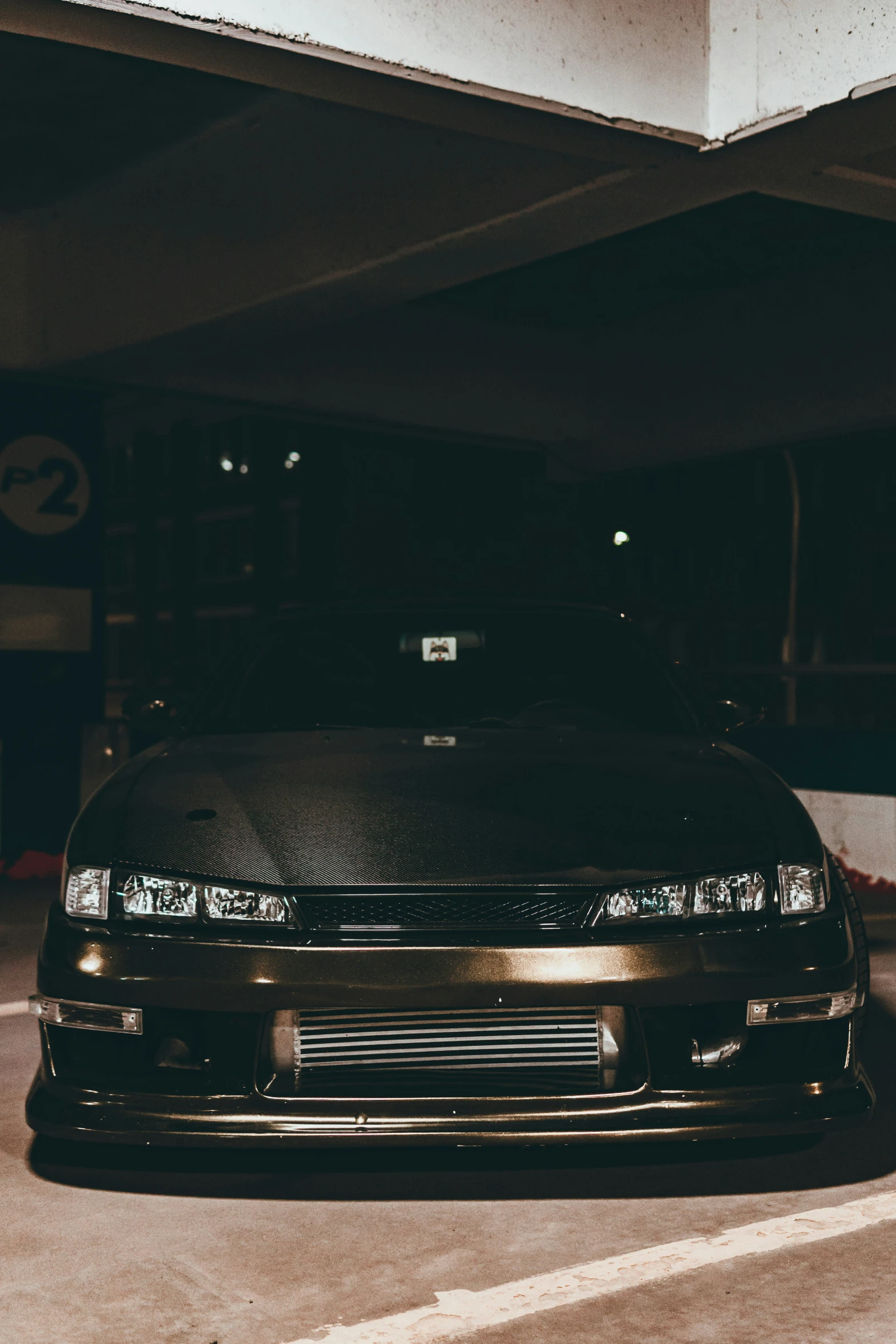 black car is parked in the parking garage