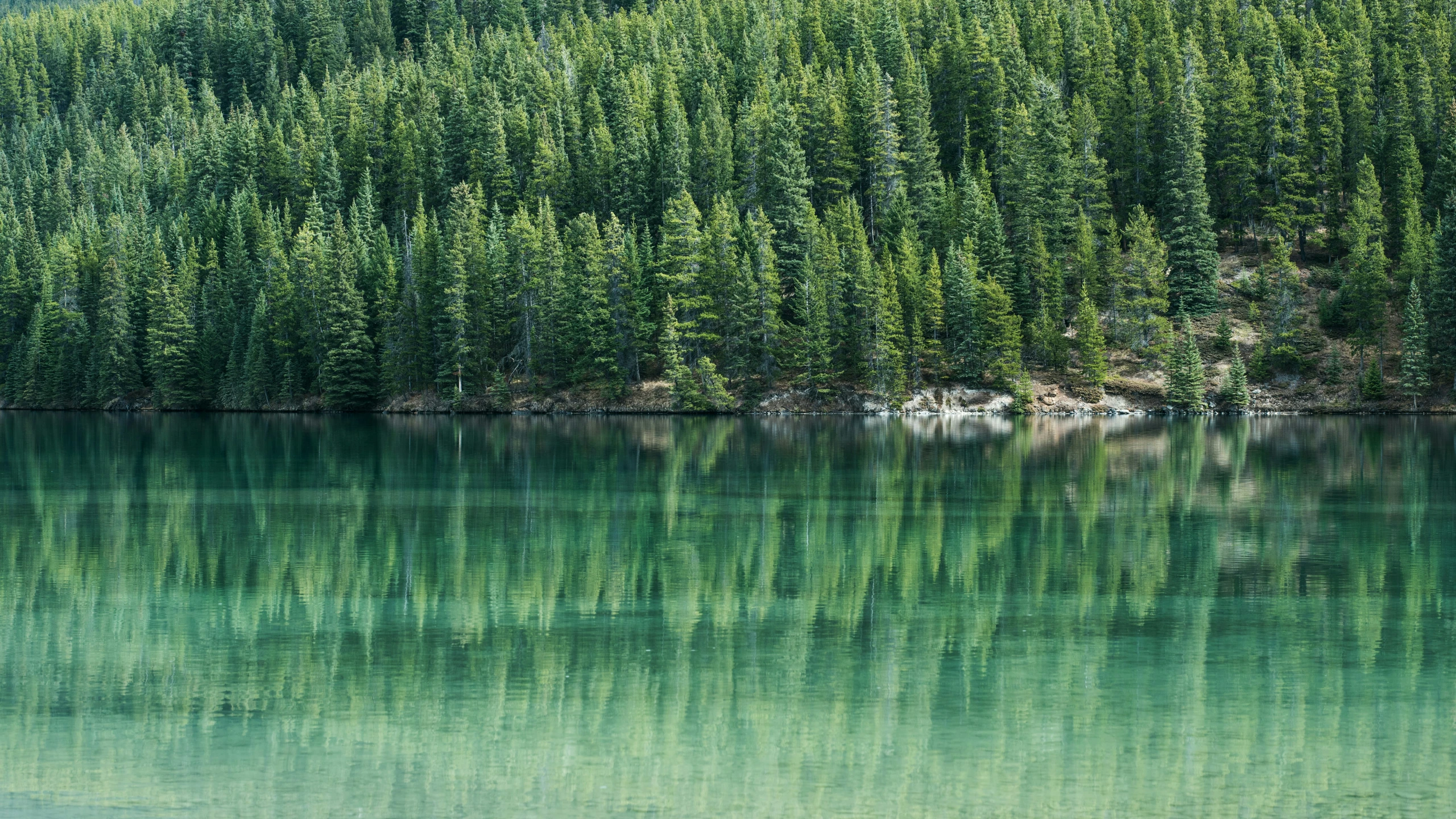 a mountain that is standing near the water