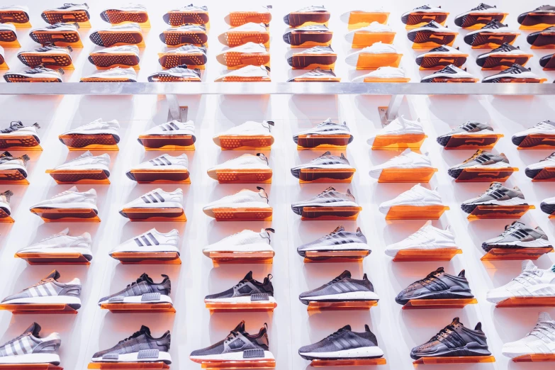 rows of running shoes arranged in a rack