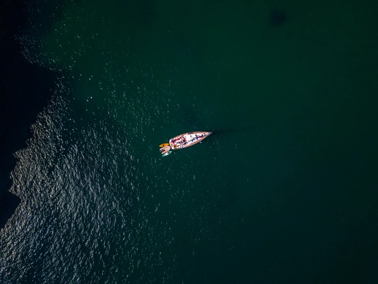 a lone boat is in a deep blue ocean