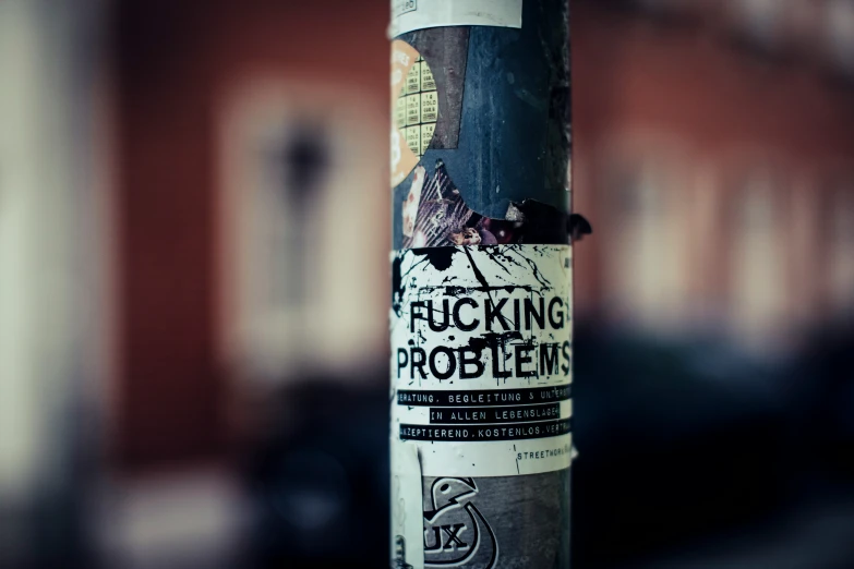 sticker on a pole is littered with bullet shells