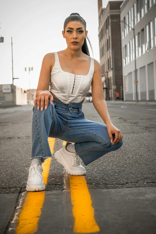 a woman in white shirt posing on yellow painted road