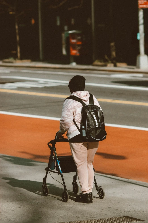 woman with a walker walks down the street